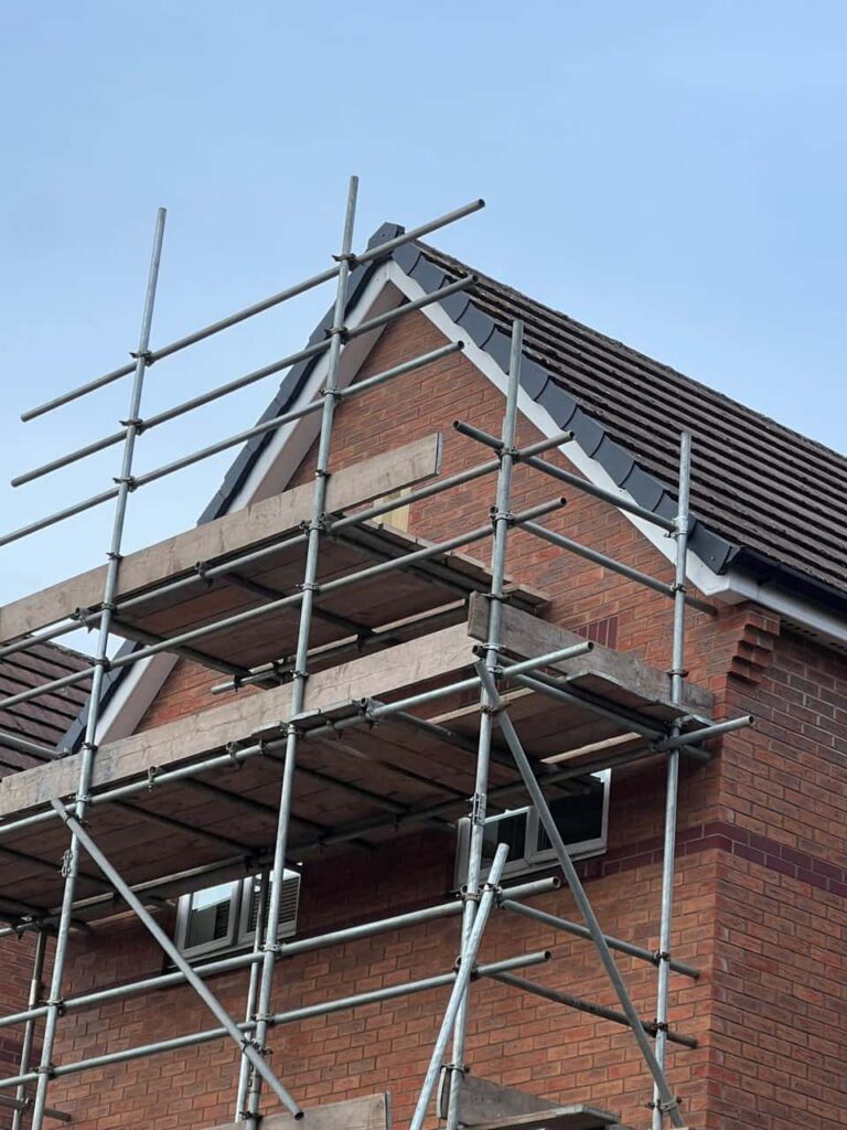 This is a photo of a roof which has just been repaired. There is a scaffold located at the gable end for access onto the roof. Works carried out by LS Roofing Burnham